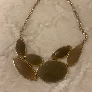 Gold tone necklace .